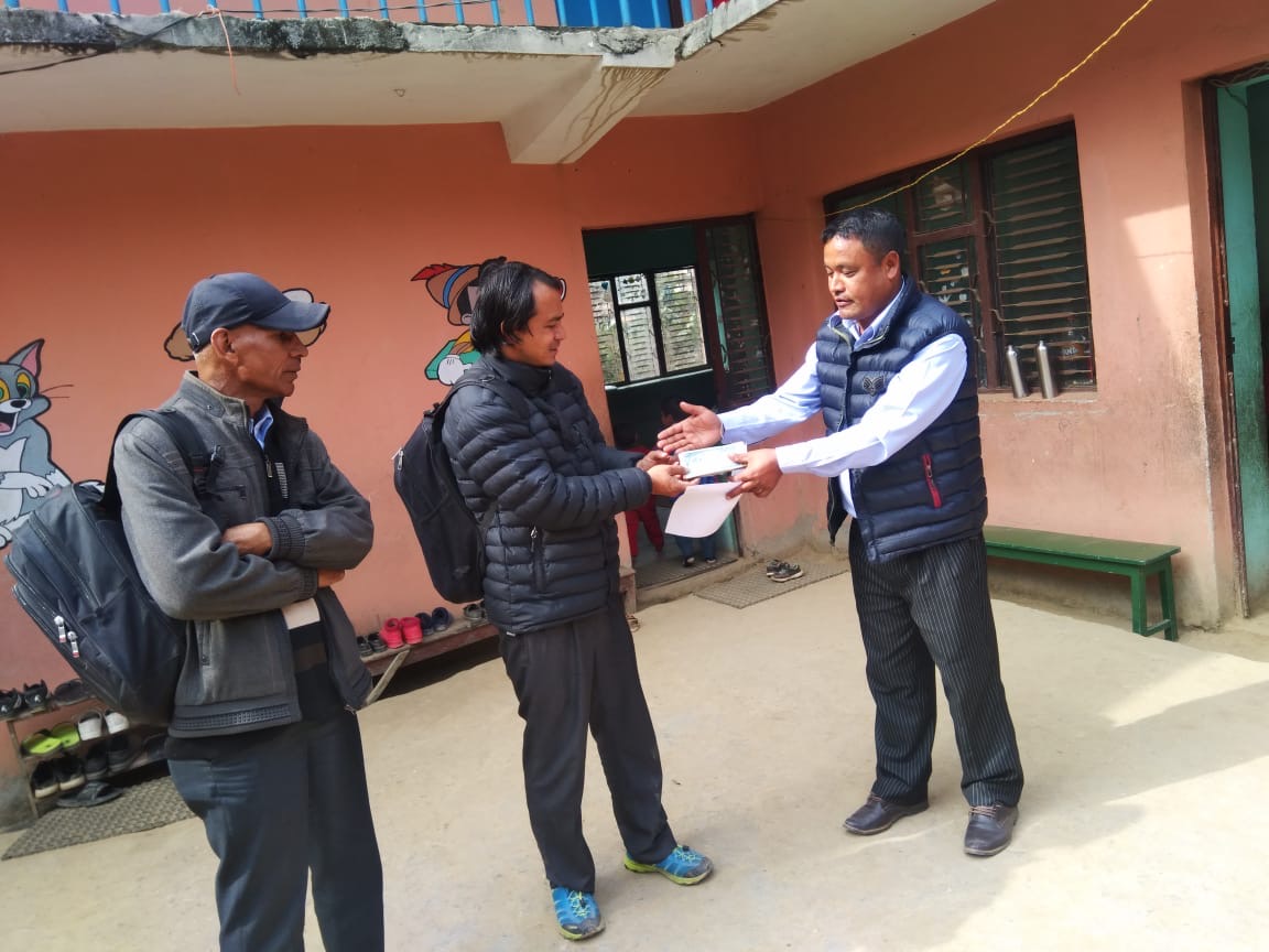 Puran Handing Funds to a School on Behalf of WIN